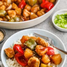 plated Sweet and Sour Chicken with pan full in the back