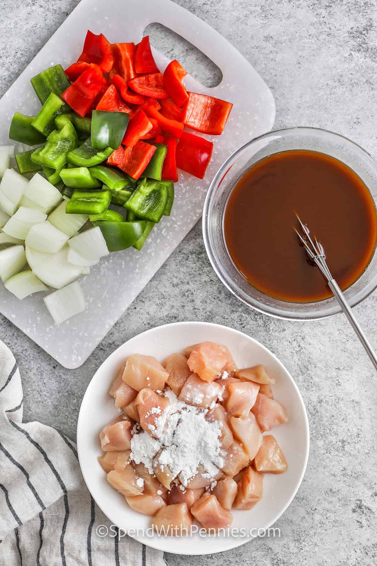 adding corn stach to chicken with bowl of sauce and chopped vegetables