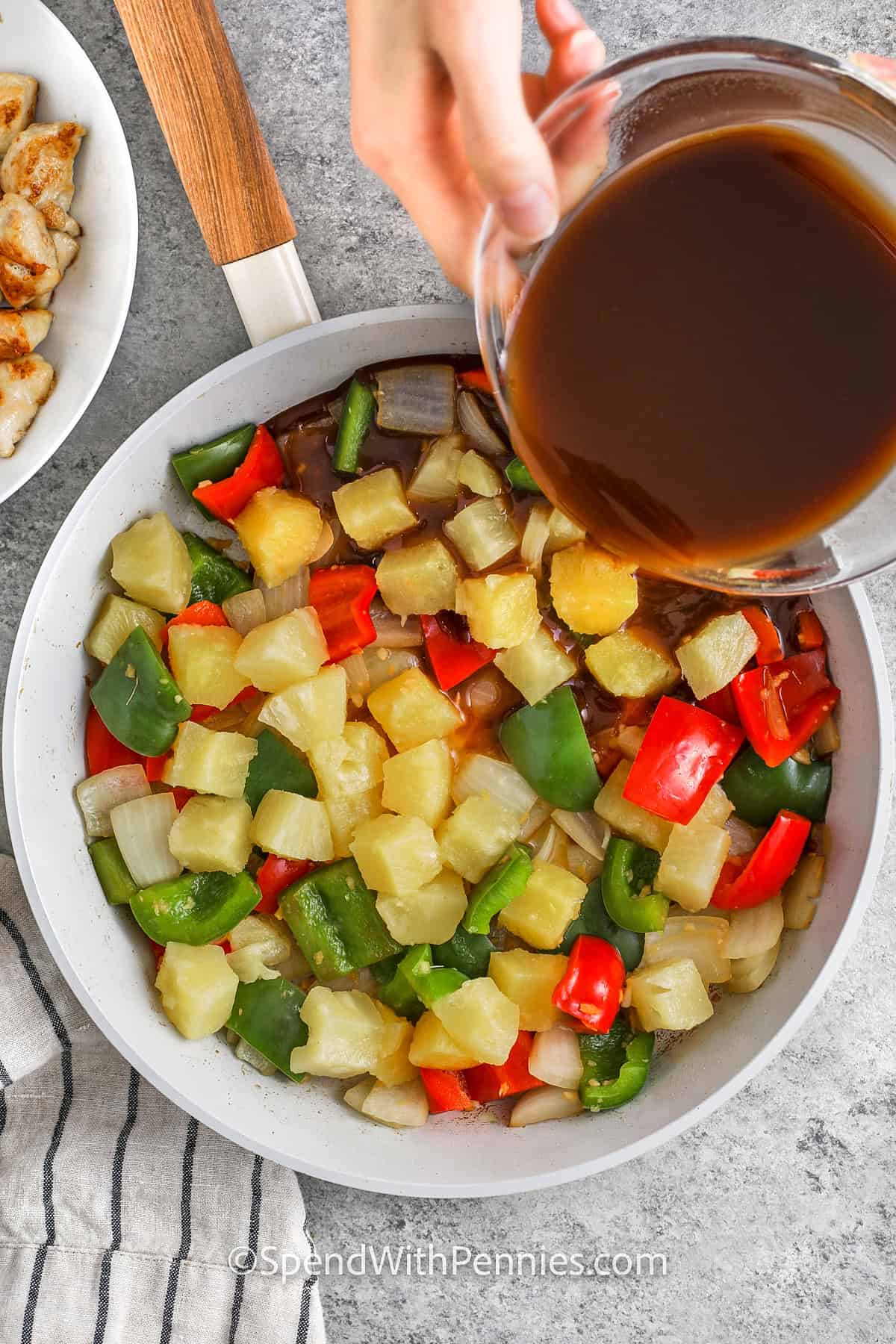 adding sauce to Sweet and Sour Chicken ingredients