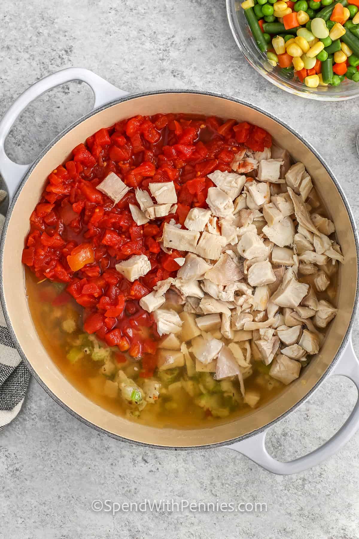 adding tomatoes and turkey to pot to make Turkey Vegetable Soup