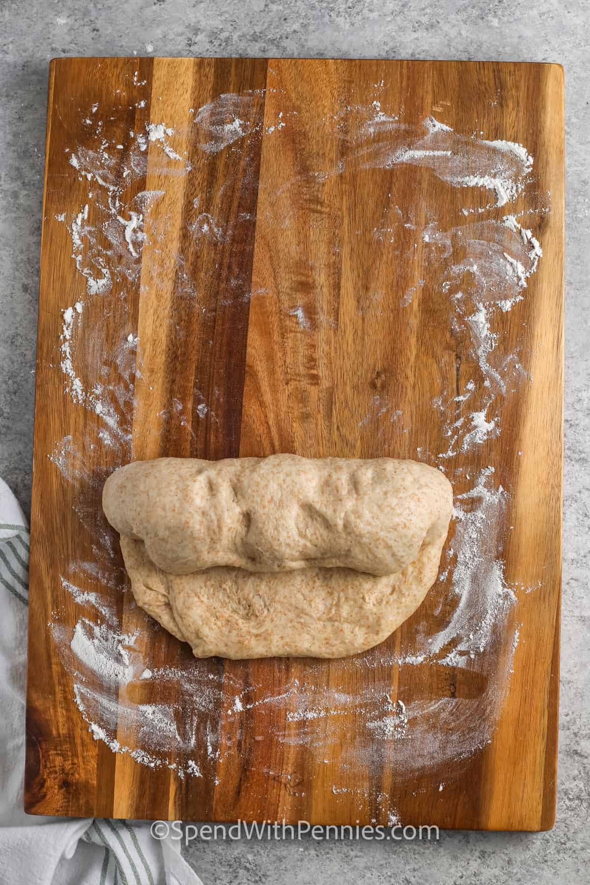 rolling Whole Wheat Bread dough into a loaf