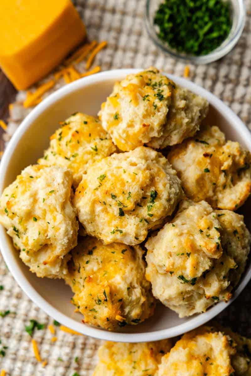 An overhead view of a bowl of cheddar bay biscuits.