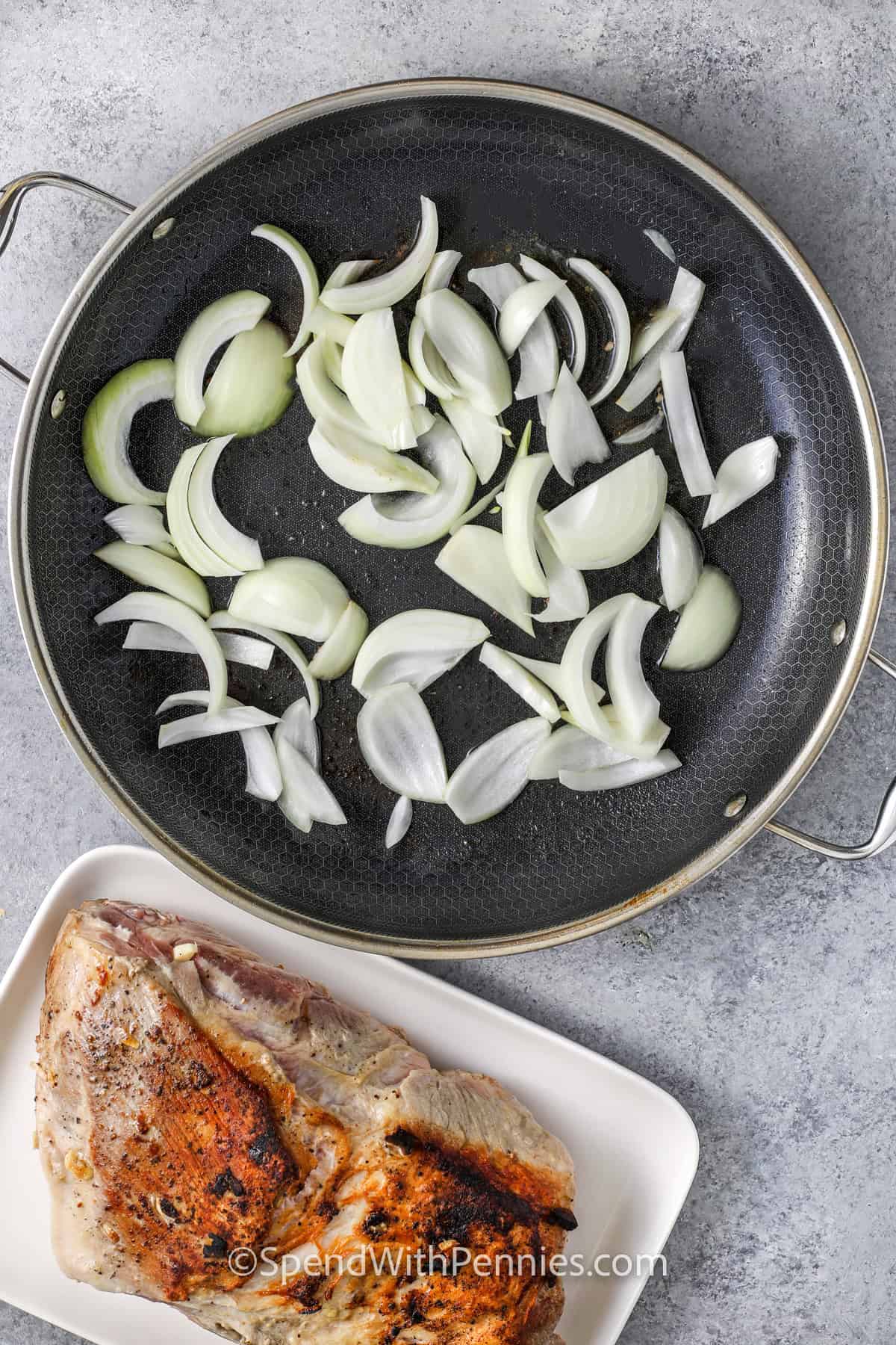 cooking onions with a cooked pot roast on a plate to make Crock Pot Pork Roast