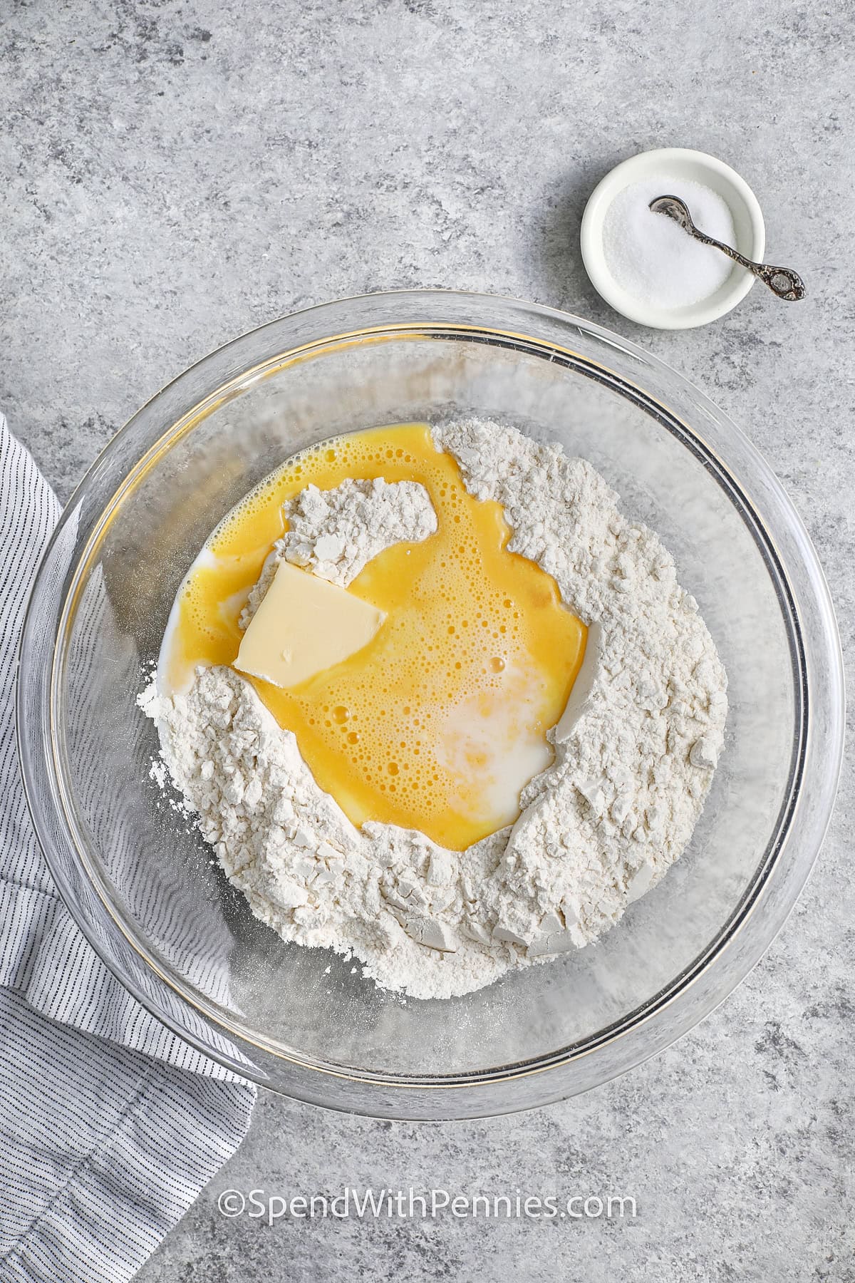 adding wet and dry ingredients to make Egg Noodles