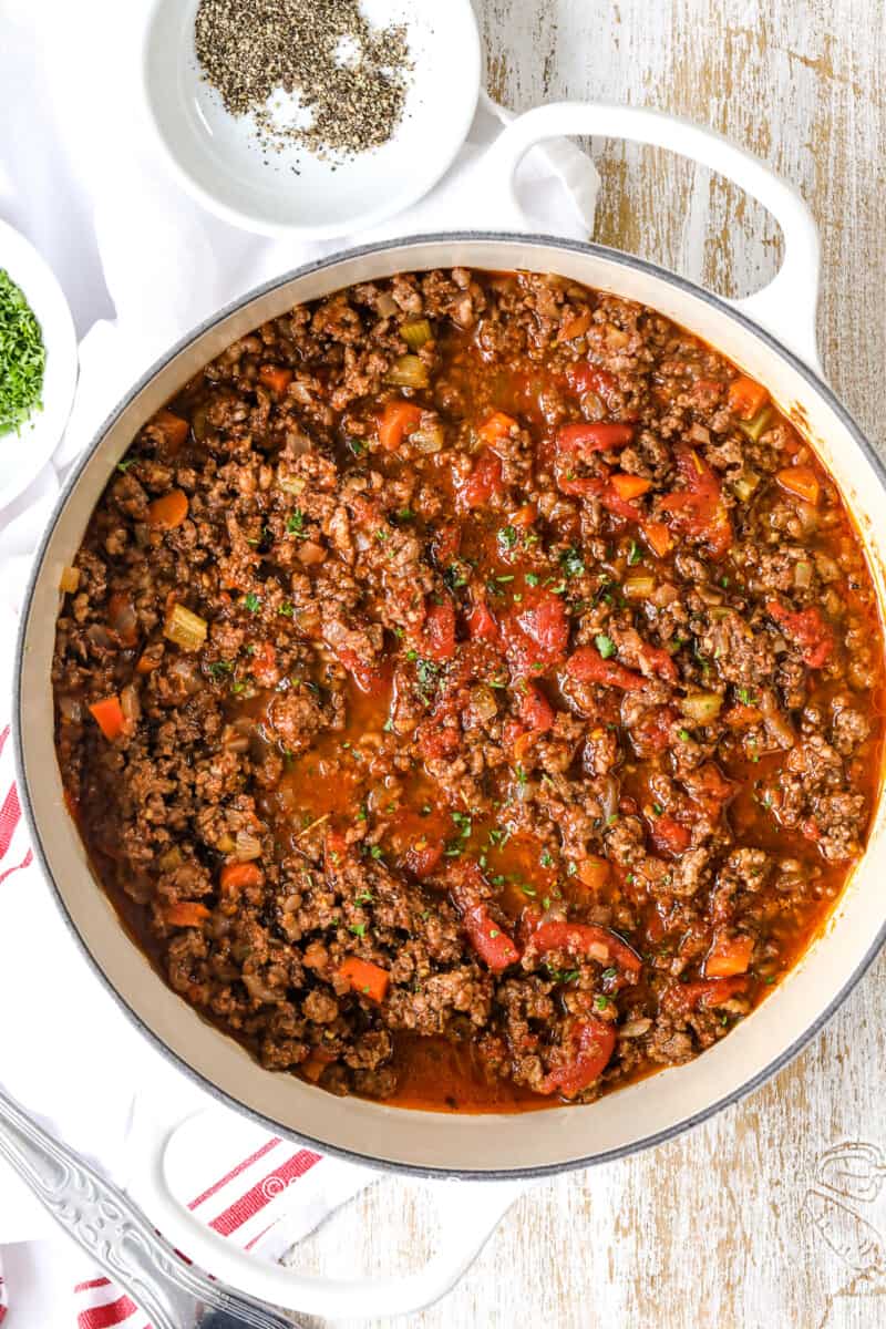 a dutch oven of cooked bolognese sauce