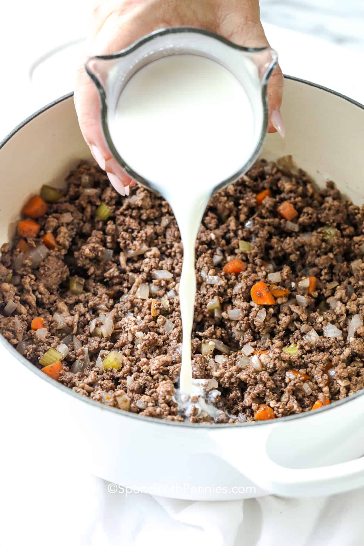 adding milk to cooked meat for bolognese