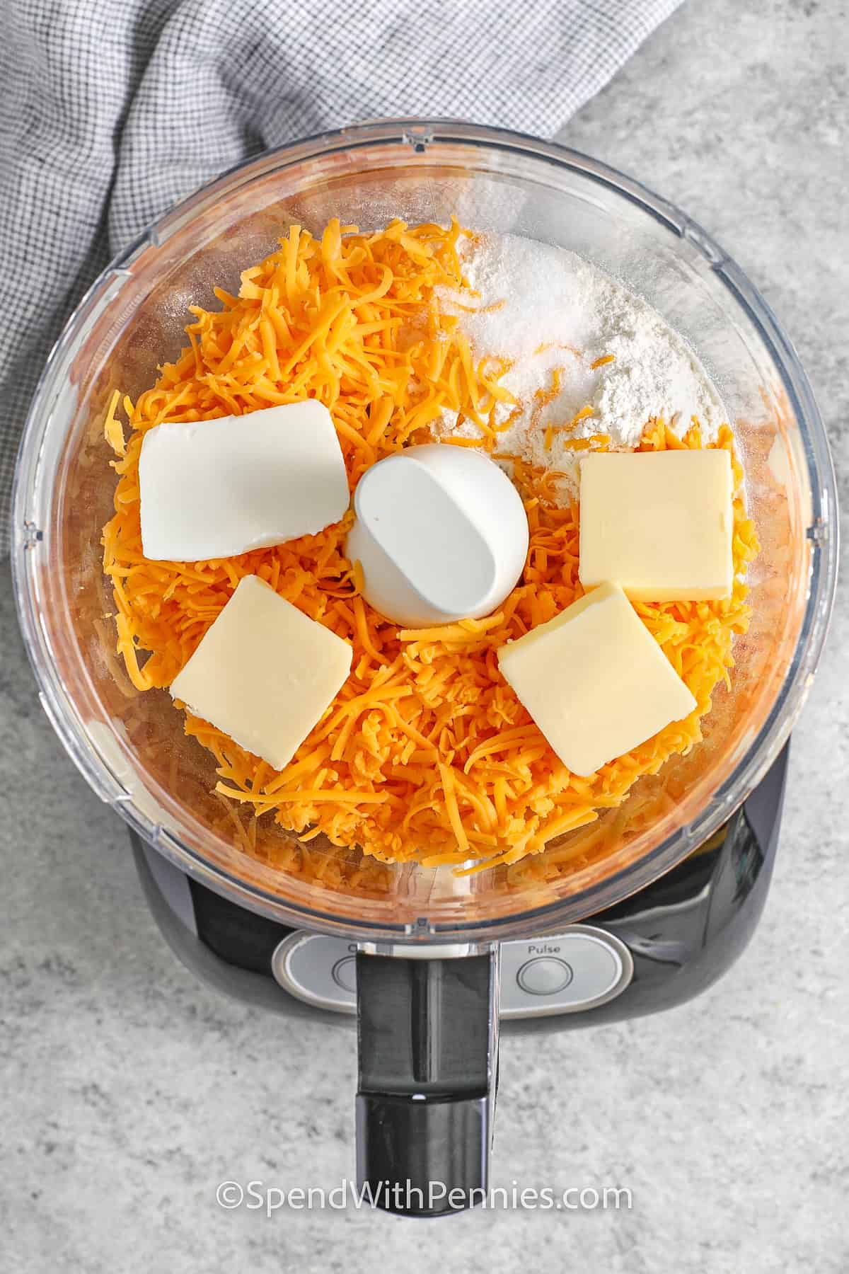 adding ingredients to food processor to make Homemade Cheez-Its