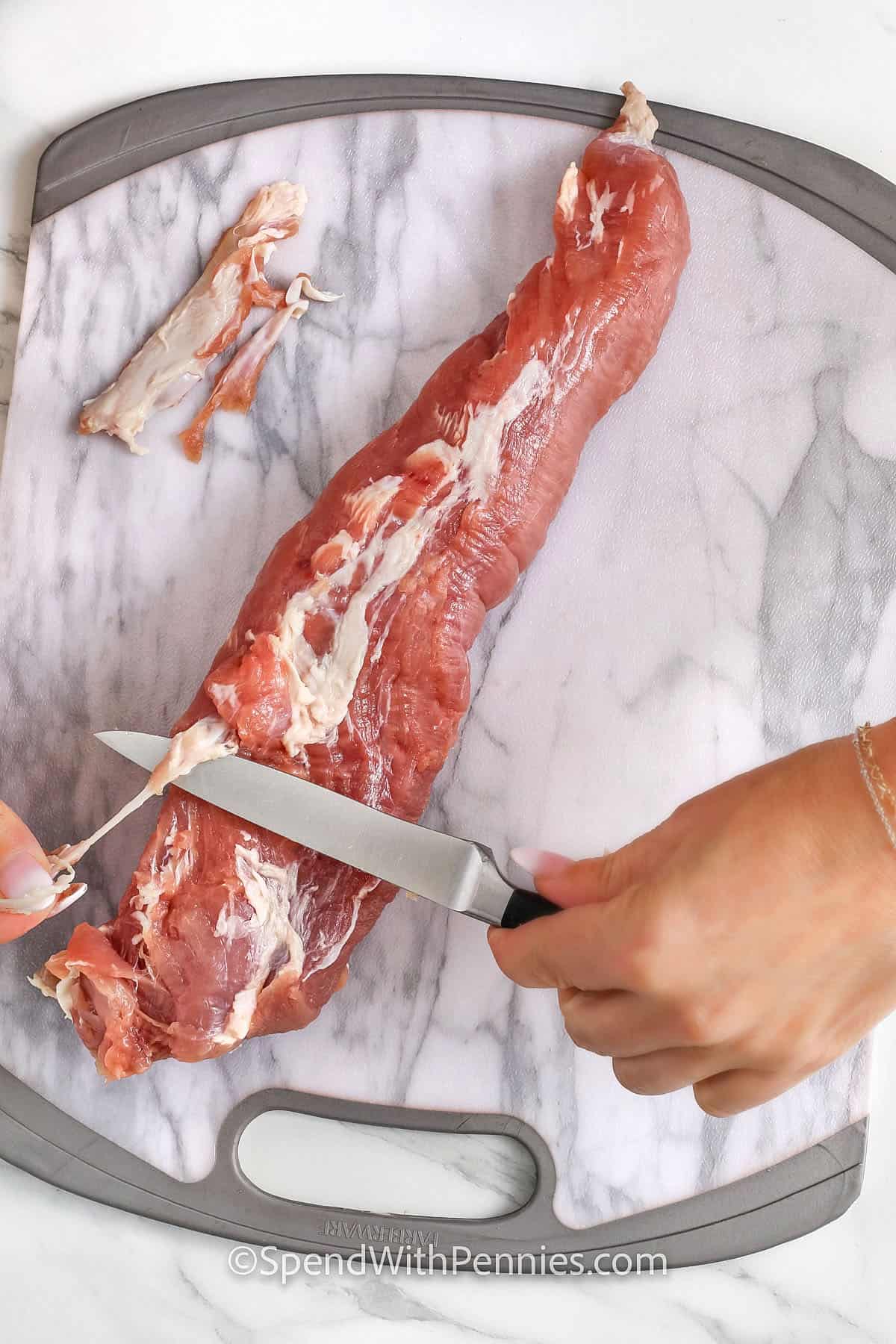 How to Remove Silverskin from Pork Tenderloin on a cutting board