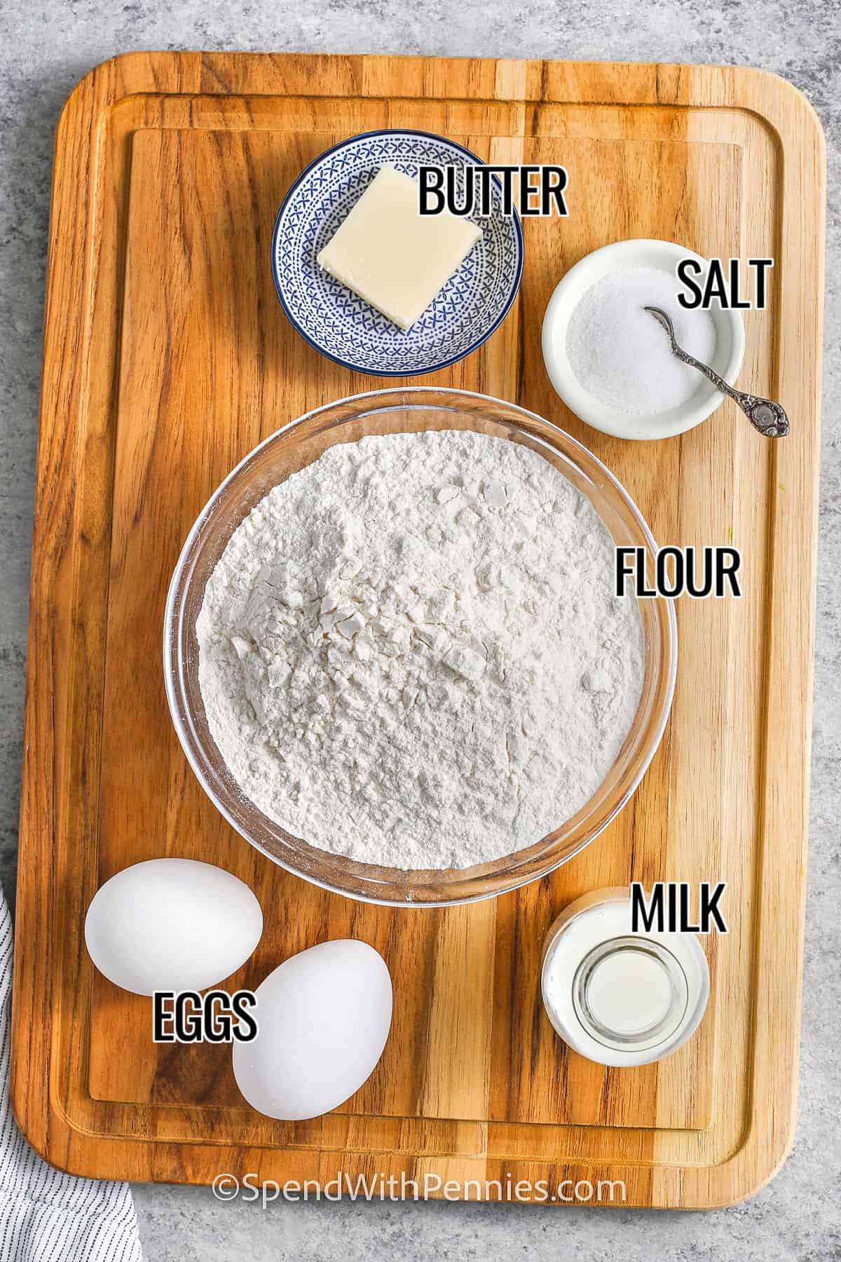 butter ,salt , flour , milk and eggs with labels to make Egg Noodles