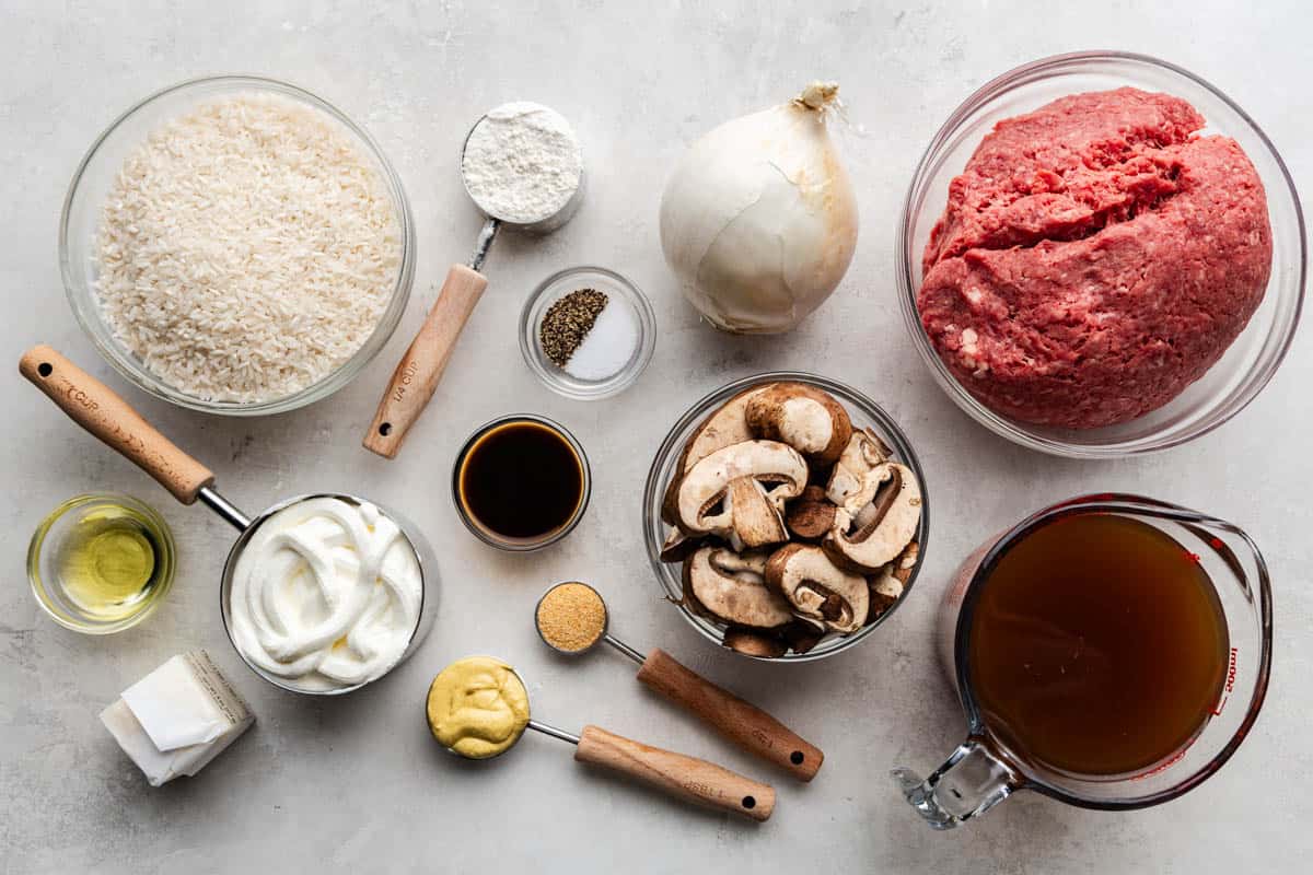 An overhead view of the ingredients needed to make ground beef stroganoff and rice.