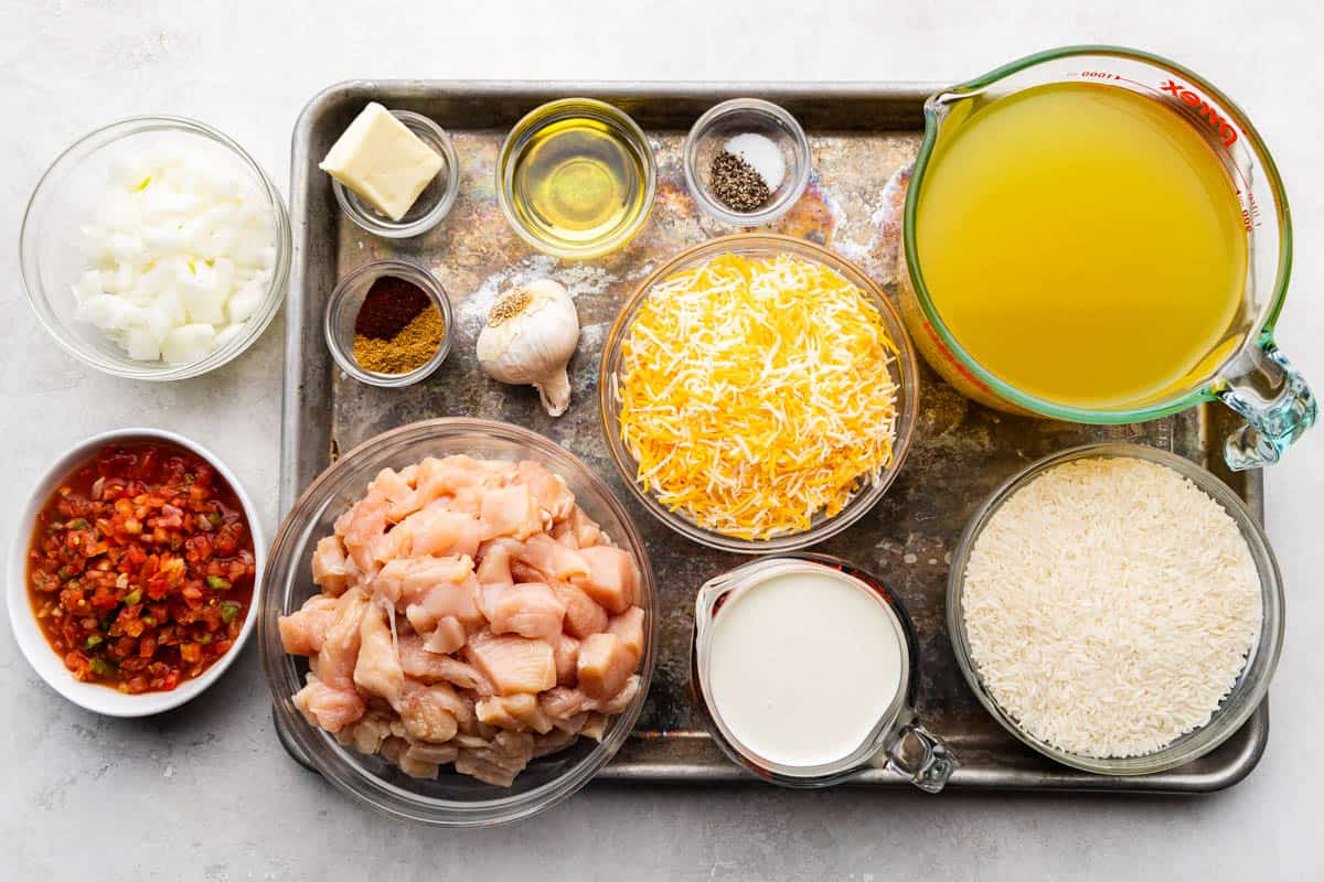 An overhead view of the ingredients needed to make one pot queso chicken and rice.