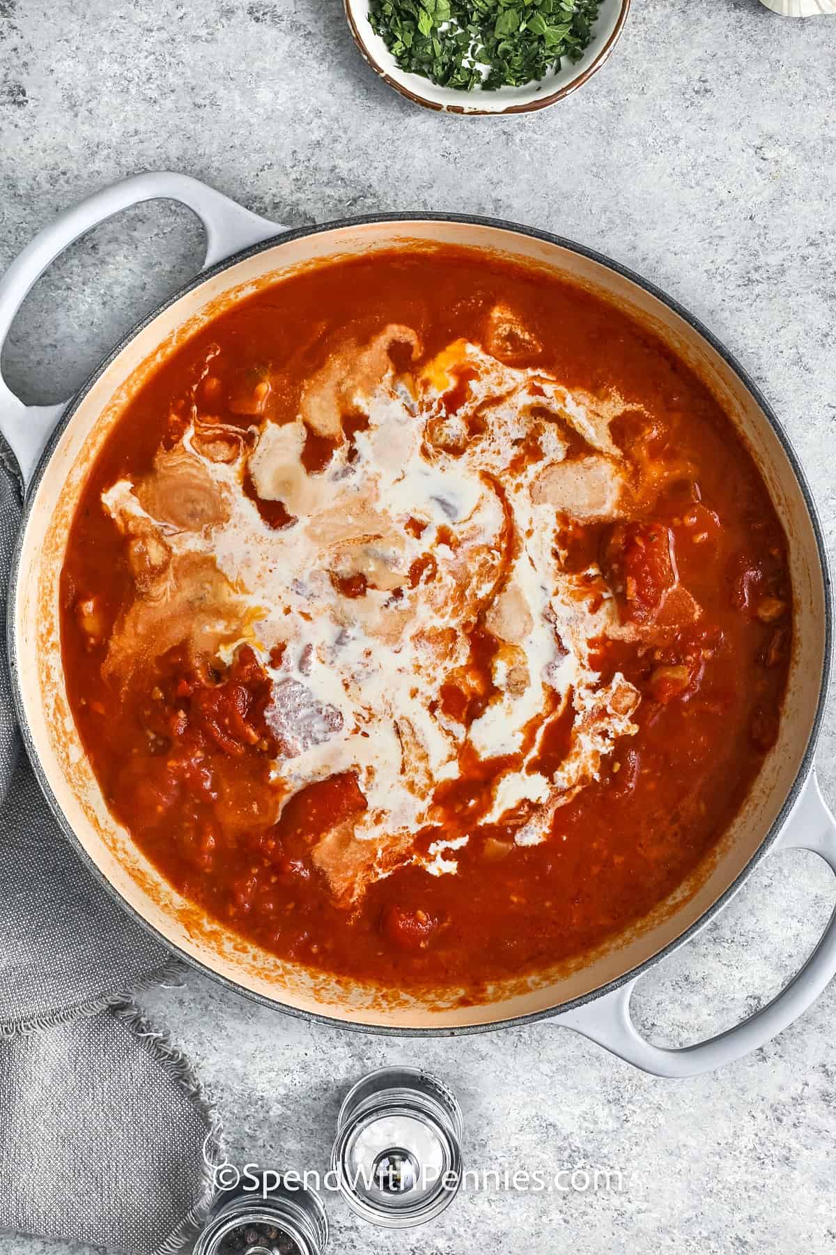 adding cream to pan to make Penne alla Vodka