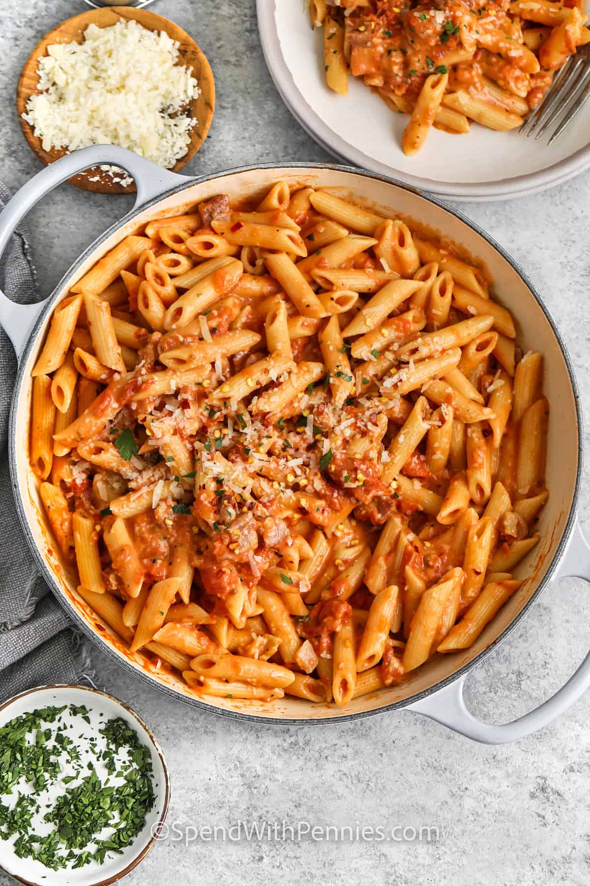 adding garnish on top of pan with Penne alla Vodka