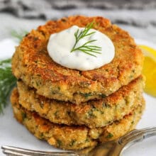 stack of Salmon Patties on a plate with sauce on top