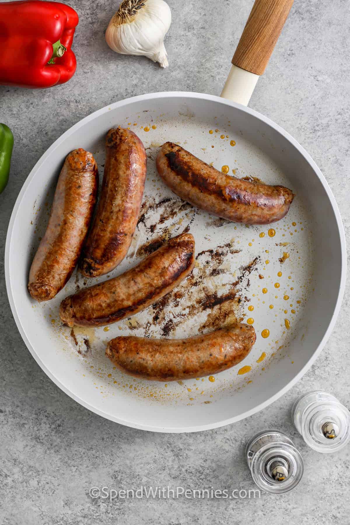 cooked sausages on a pan to make Sausage and Peppers