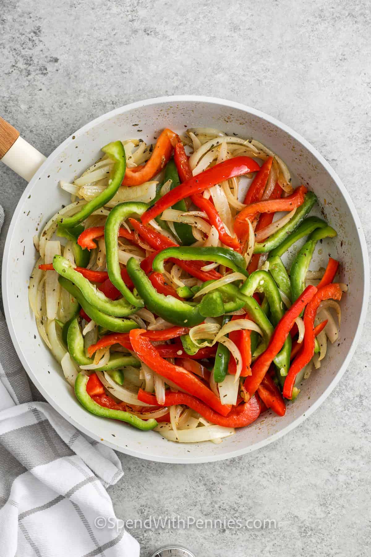 adding peppers to pan to make Sausage and Peppers