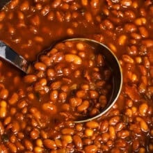 pot of Slow Cooker Baked Beans with a spoon