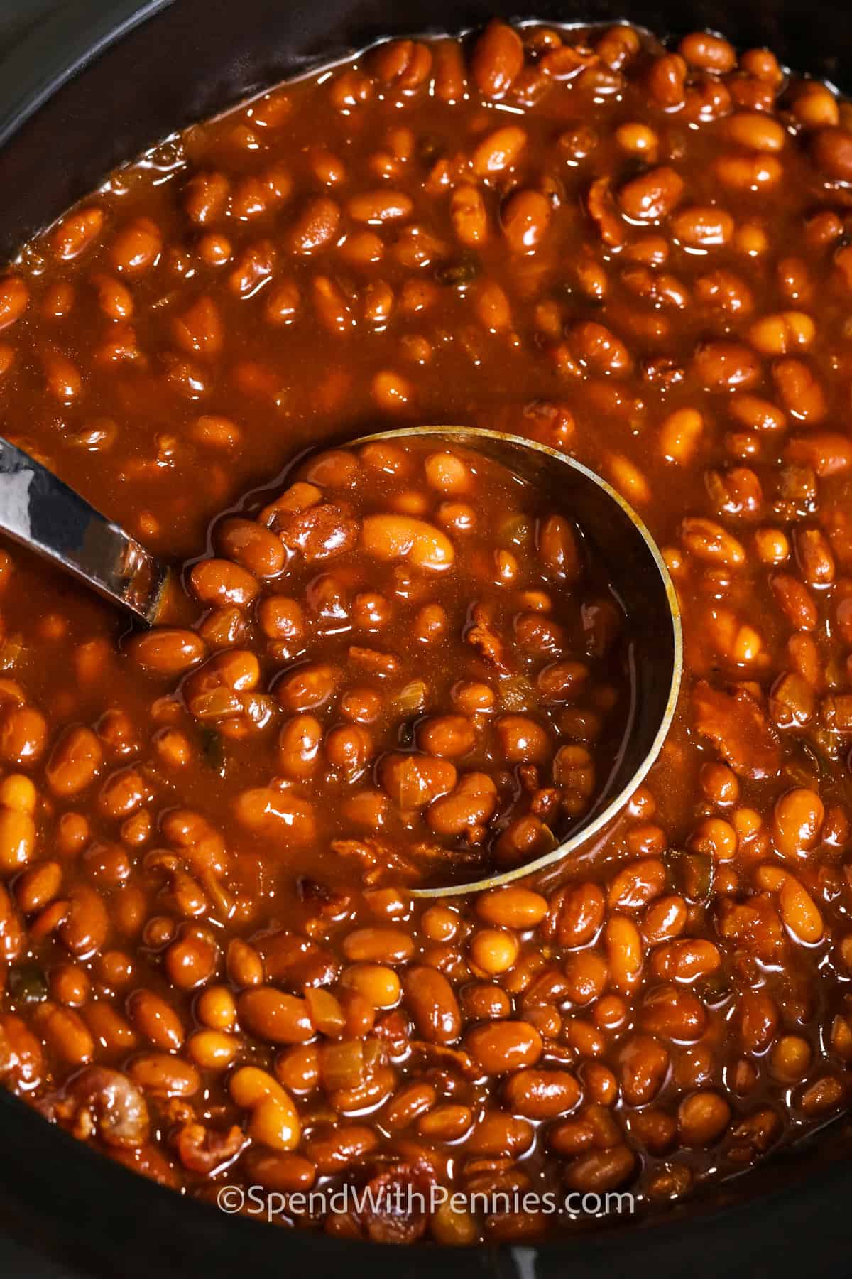 pot of Slow Cooker Baked Beans with a spoon