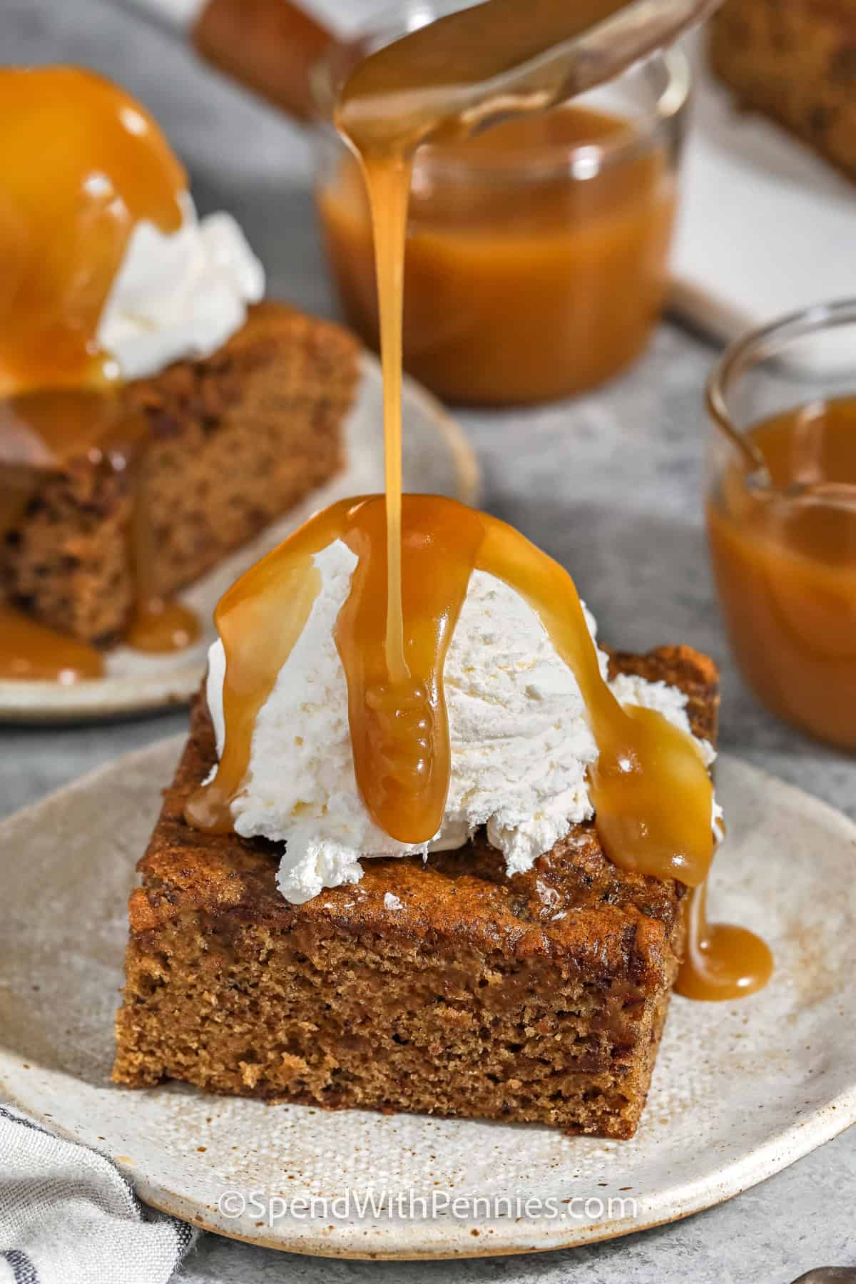 pouring toffee sauce over Sticky Toffee Pudding slice