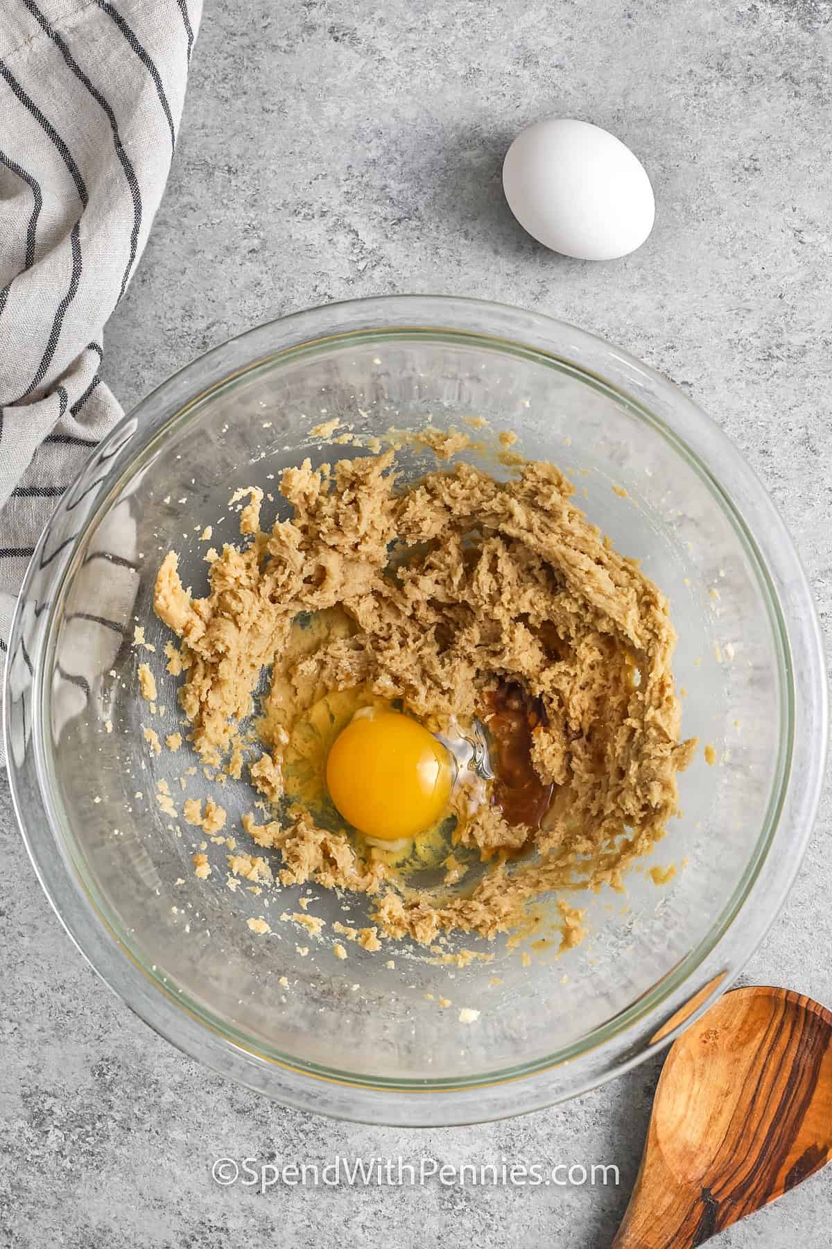 adding egg to wet ingredients to make Sticky Toffee Pudding