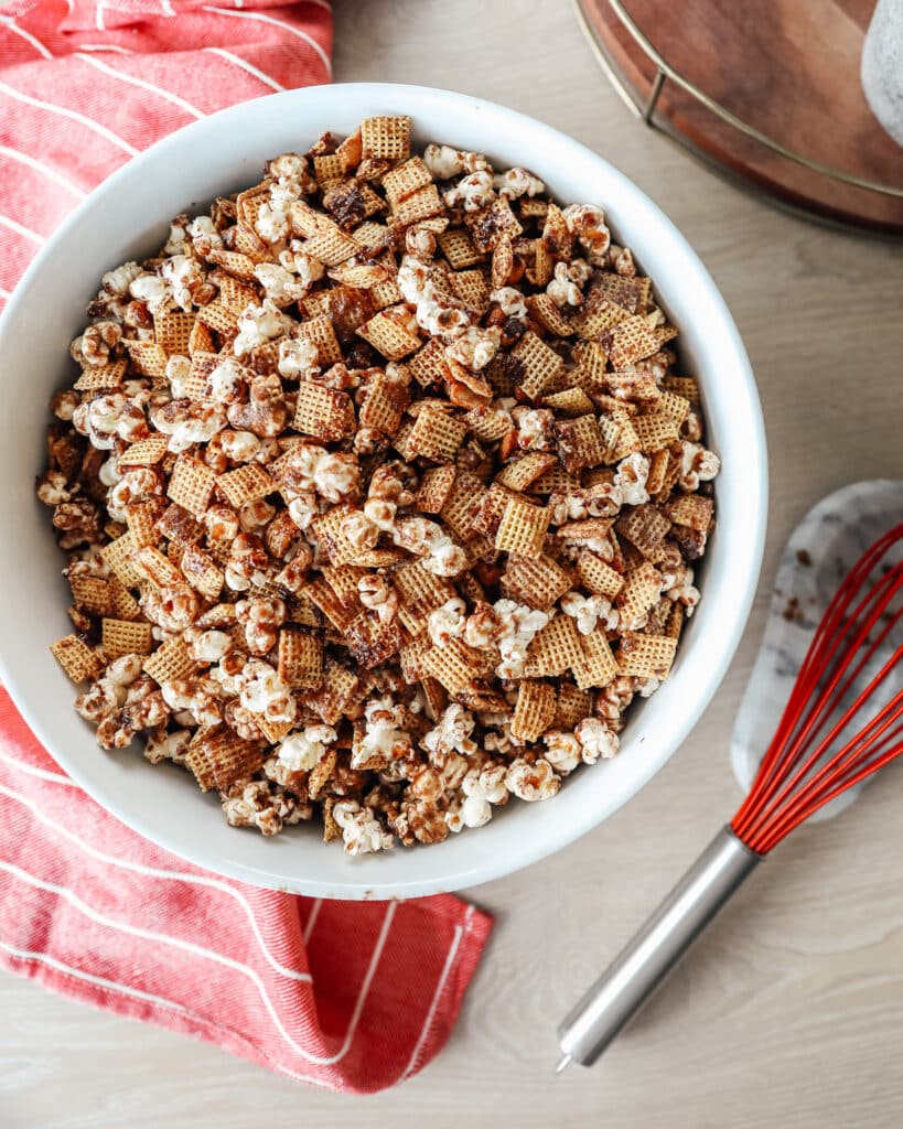 A bowl of peanut butter caramel popcorn with chex mix. 