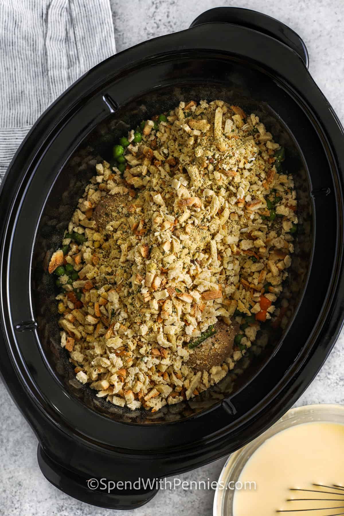 adding stuffing mix to crockpot to make Crockpot Chicken and Stuffing