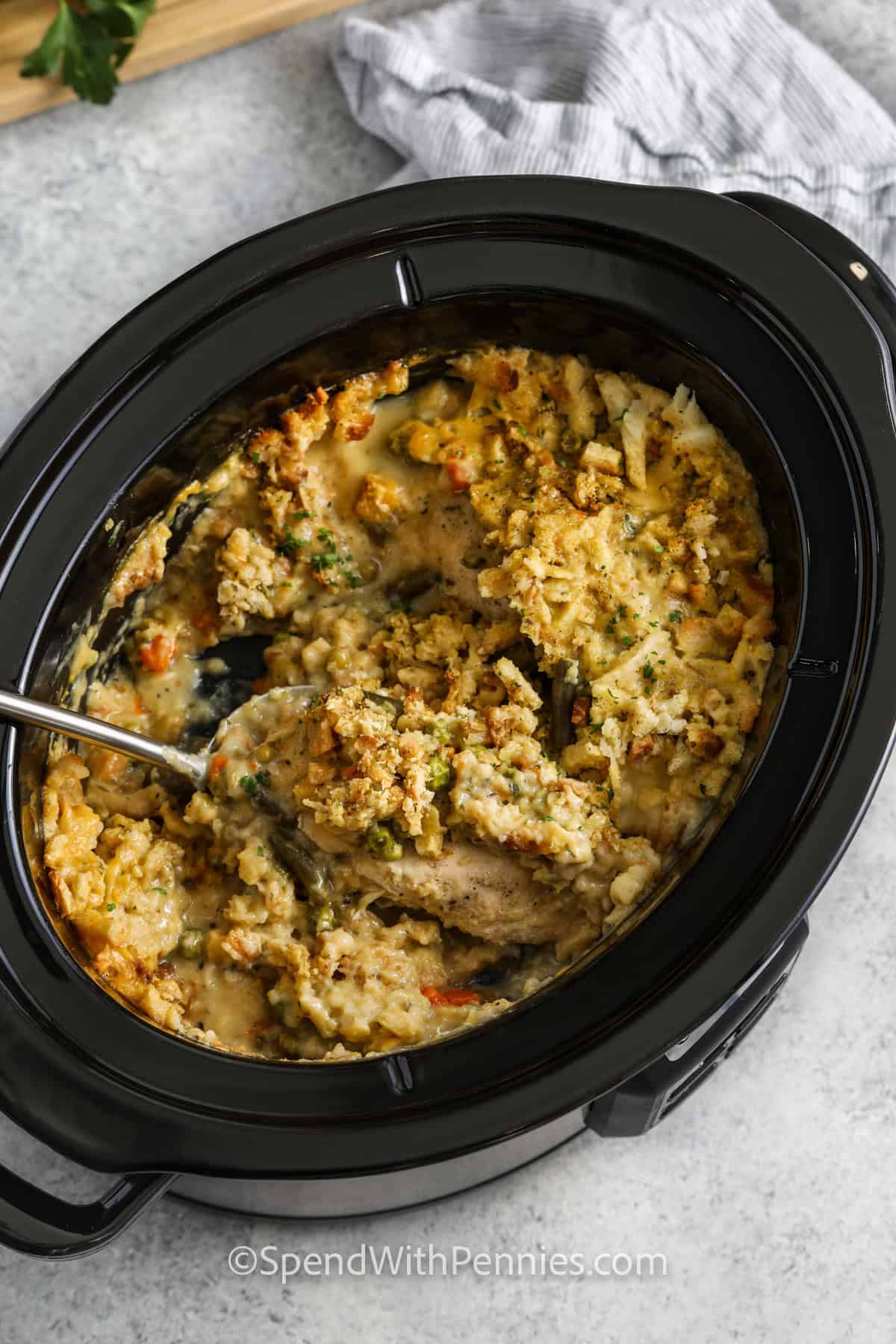 taking a spoonfull of Crockpot Chicken and Stuffing out of the pot