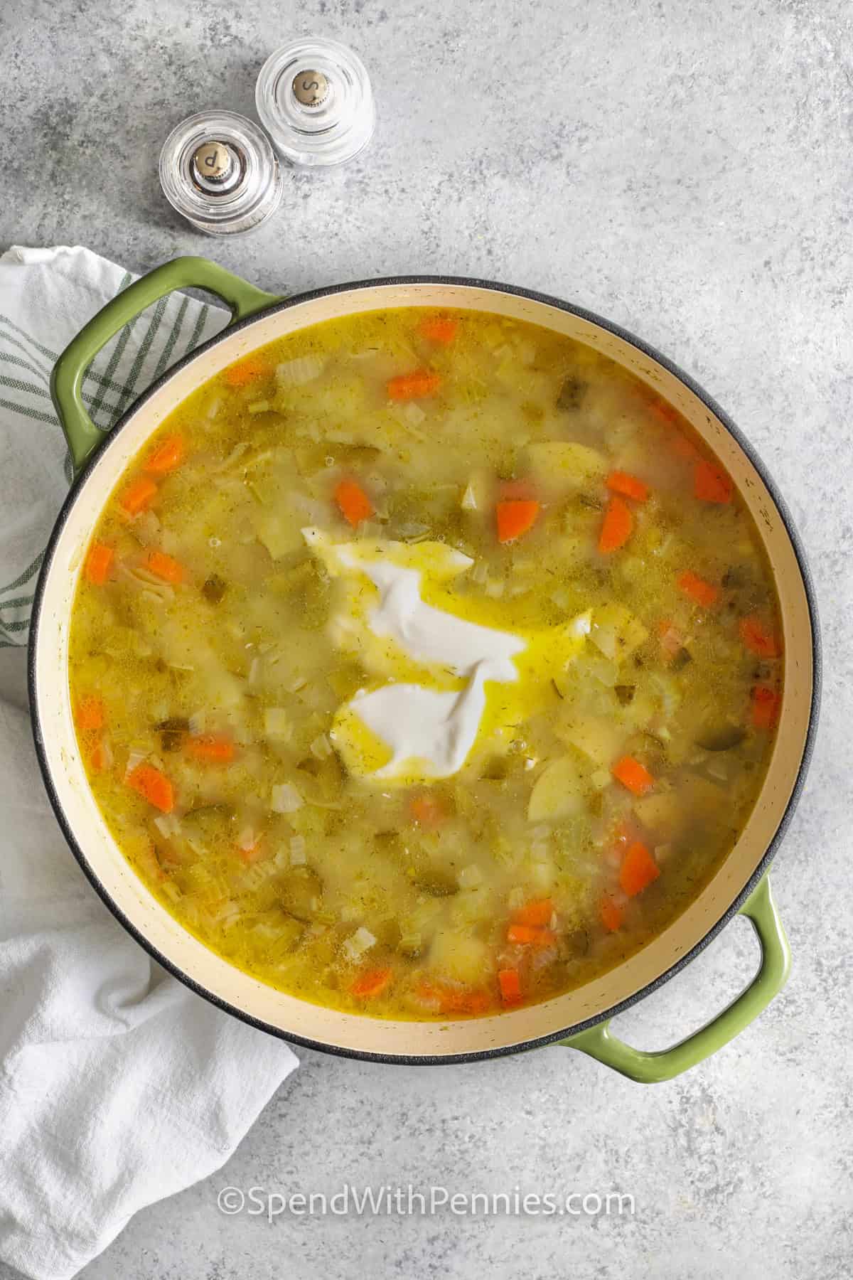 adding sour cream to pan to make Dill Pickle Soup