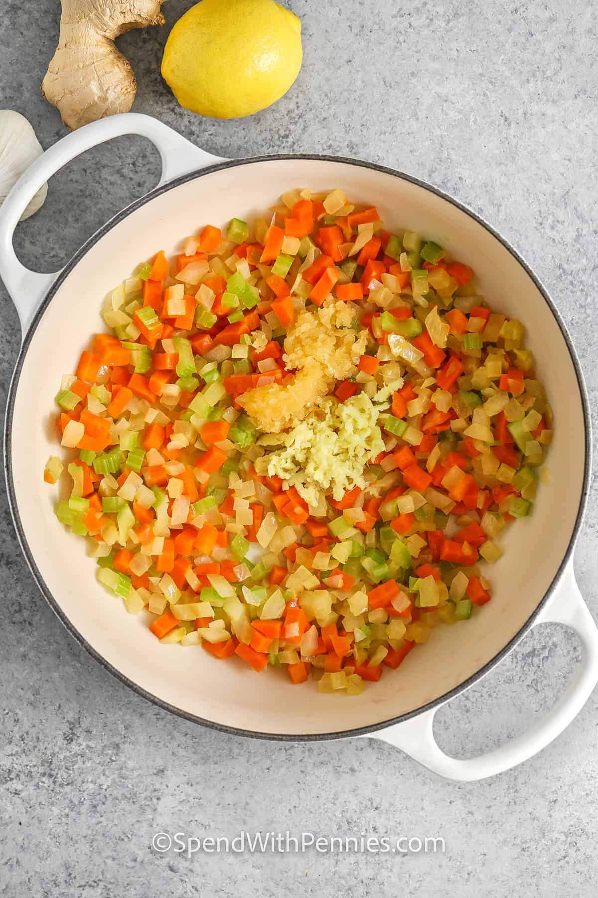 adding garlic and ginger to vegetables to make Feel Better Chicken Soup