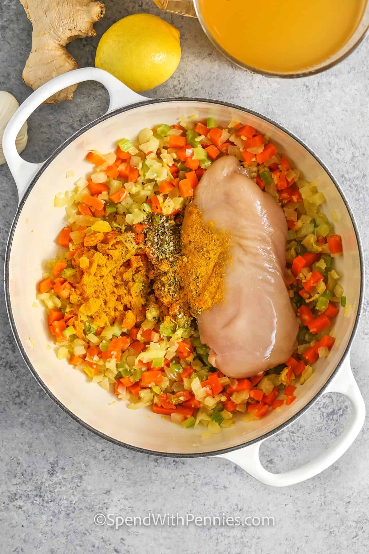 adding chicken and seasoning to cooked vegetables to make Feel Better Chicken Soup