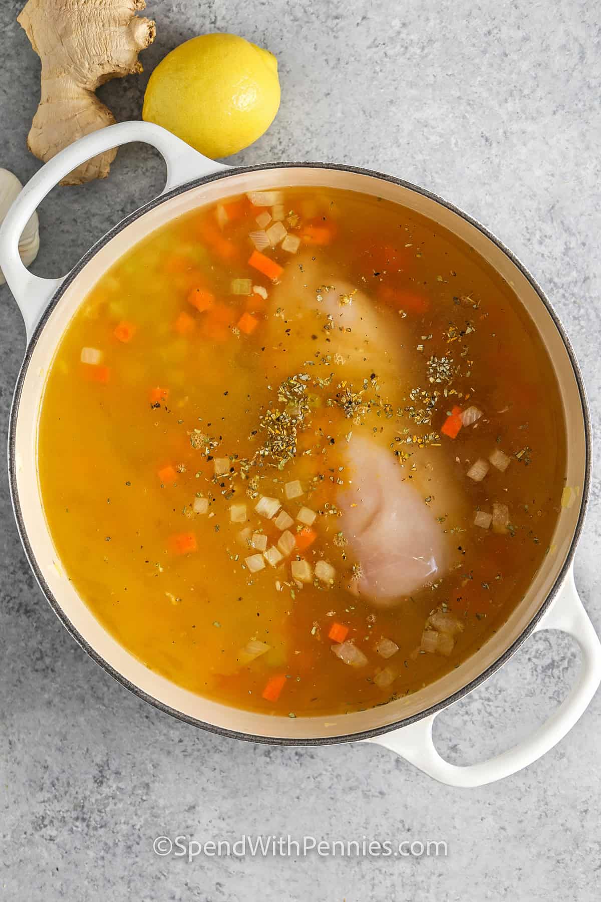 adding chicken and broth to pan to make Feel Better Chicken Soup