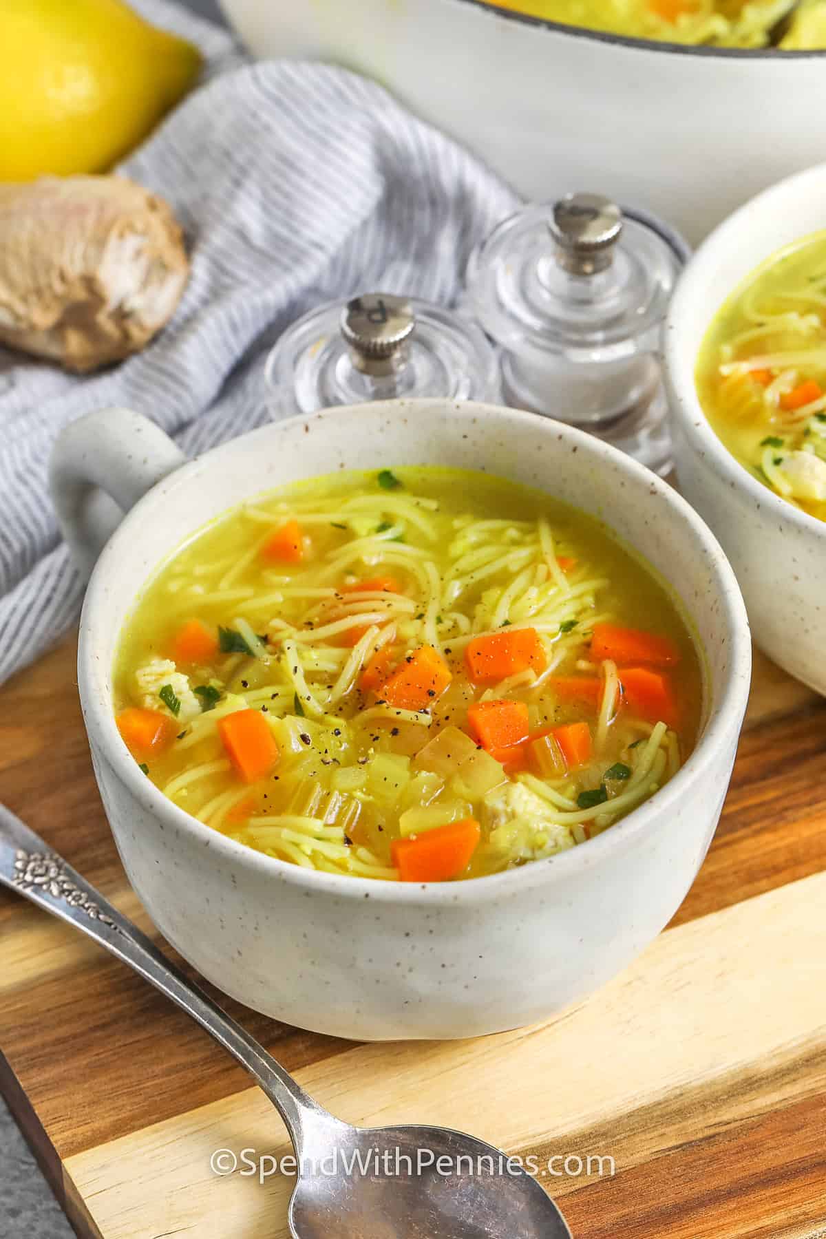 bowls of Feel Better Chicken Soup with pot full in the back