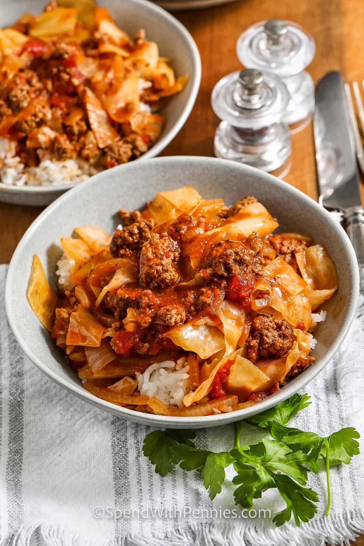 two bowls of ground beef and cabbage