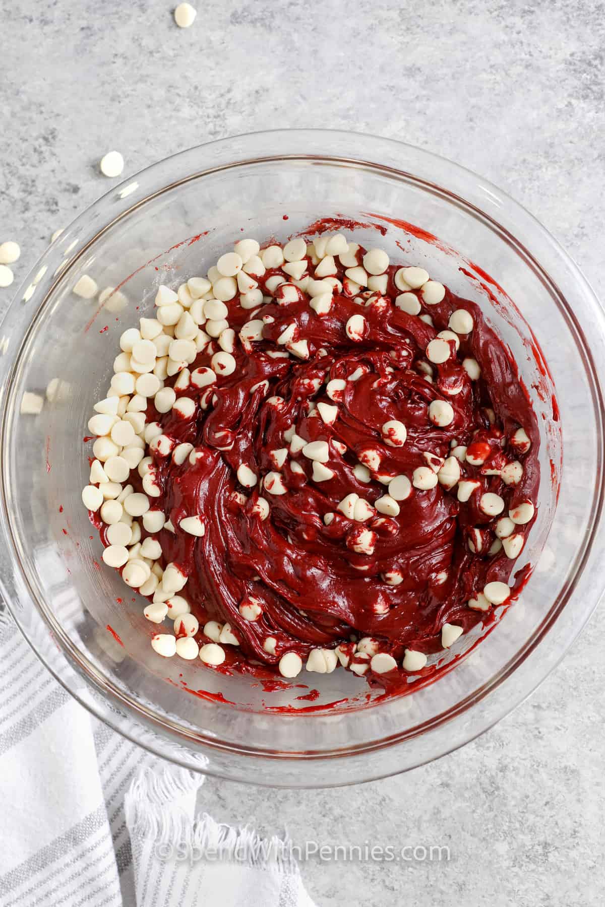 adding chocolate chips to bowl to make Red Velvet Cake Mix Cookies