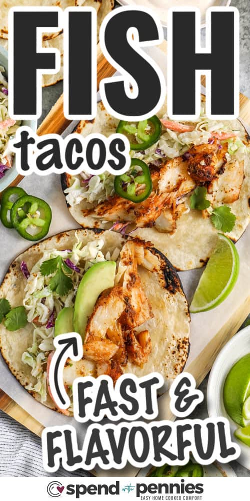 open faced Fish Tacos on a wooden board with writing