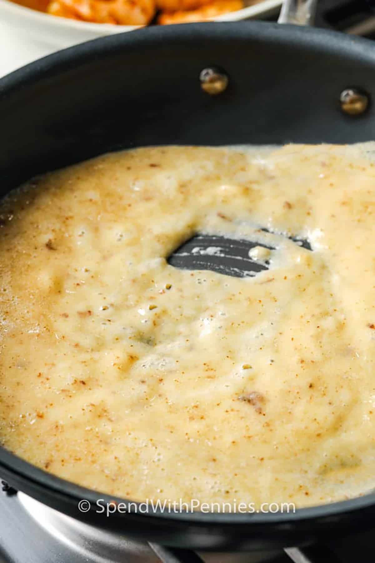 Roux bubbling in a pan to make shrimp etouffee.