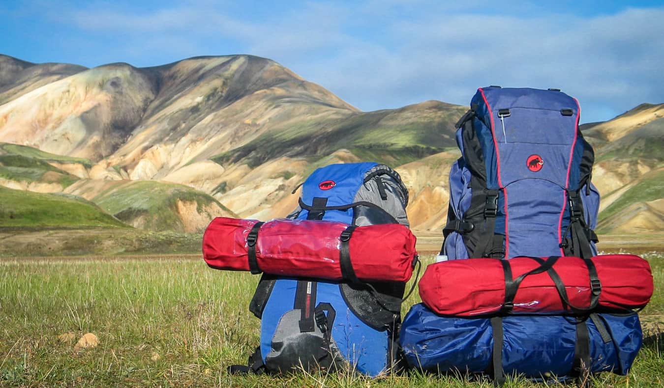 A bunch of hiking gear in an empty field