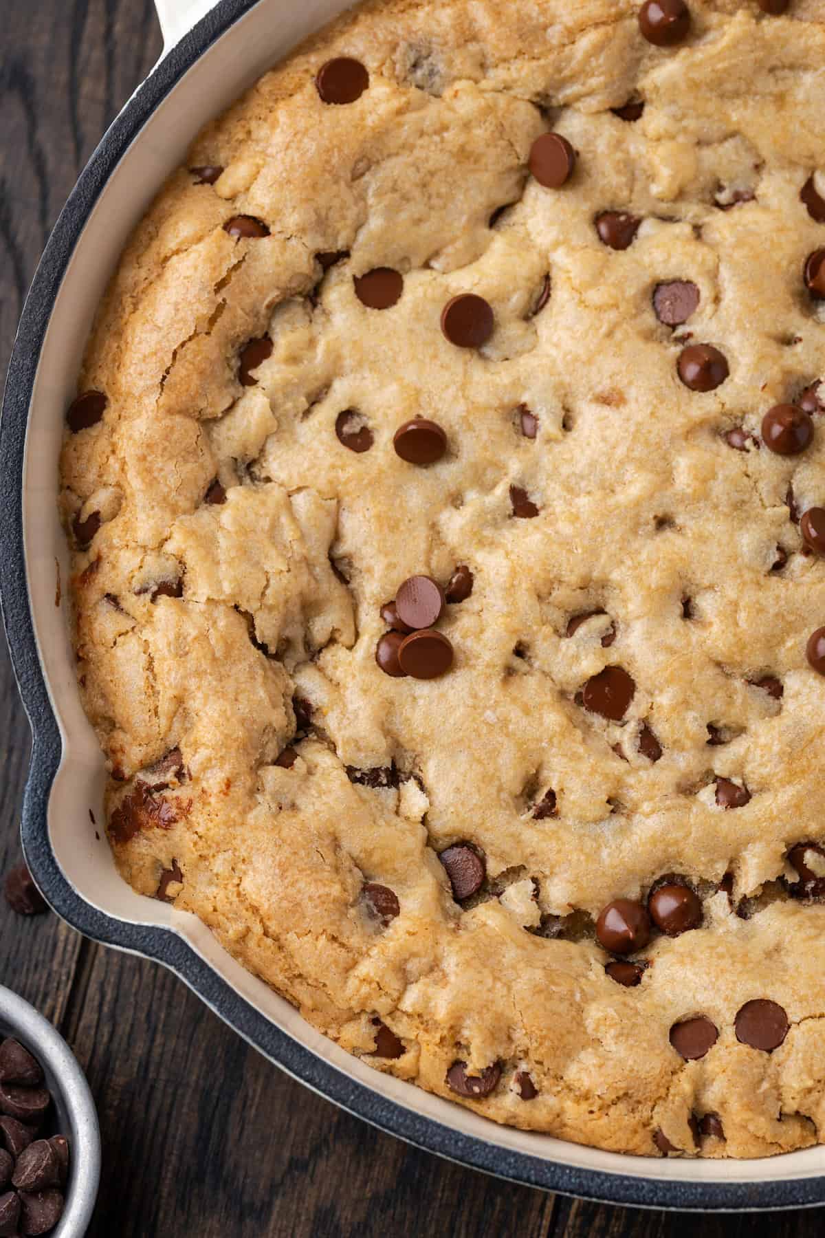 Overhead view of a skillet chocolate chip cookie.