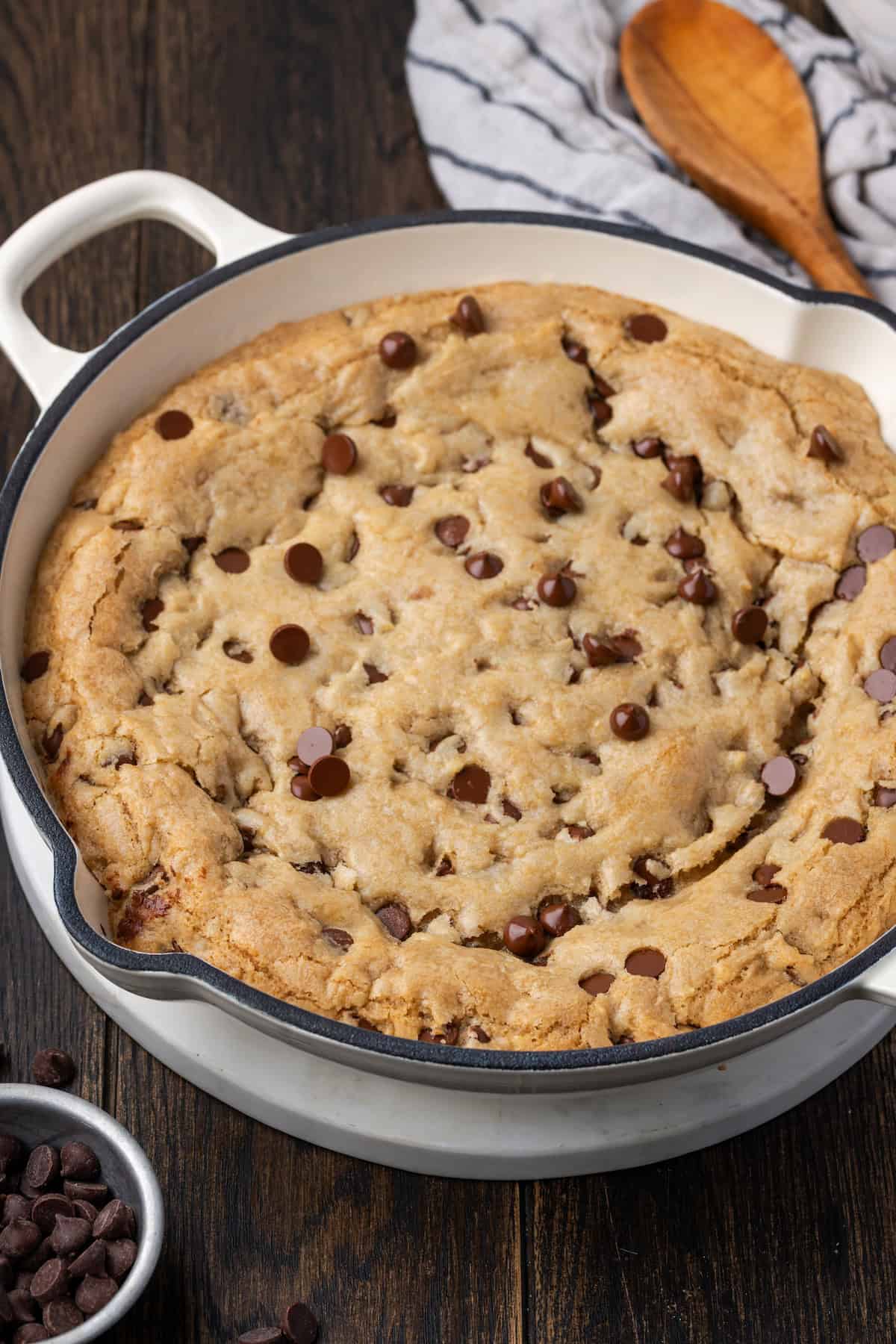 A skillet chocolate chip cookie in a large cast iron skillet.